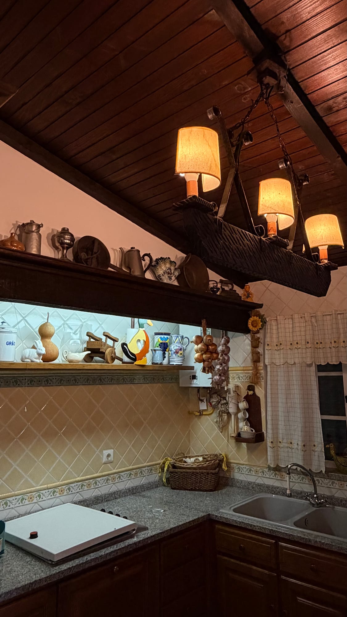 Prateleira rústica com loiça e objetos tradicionais